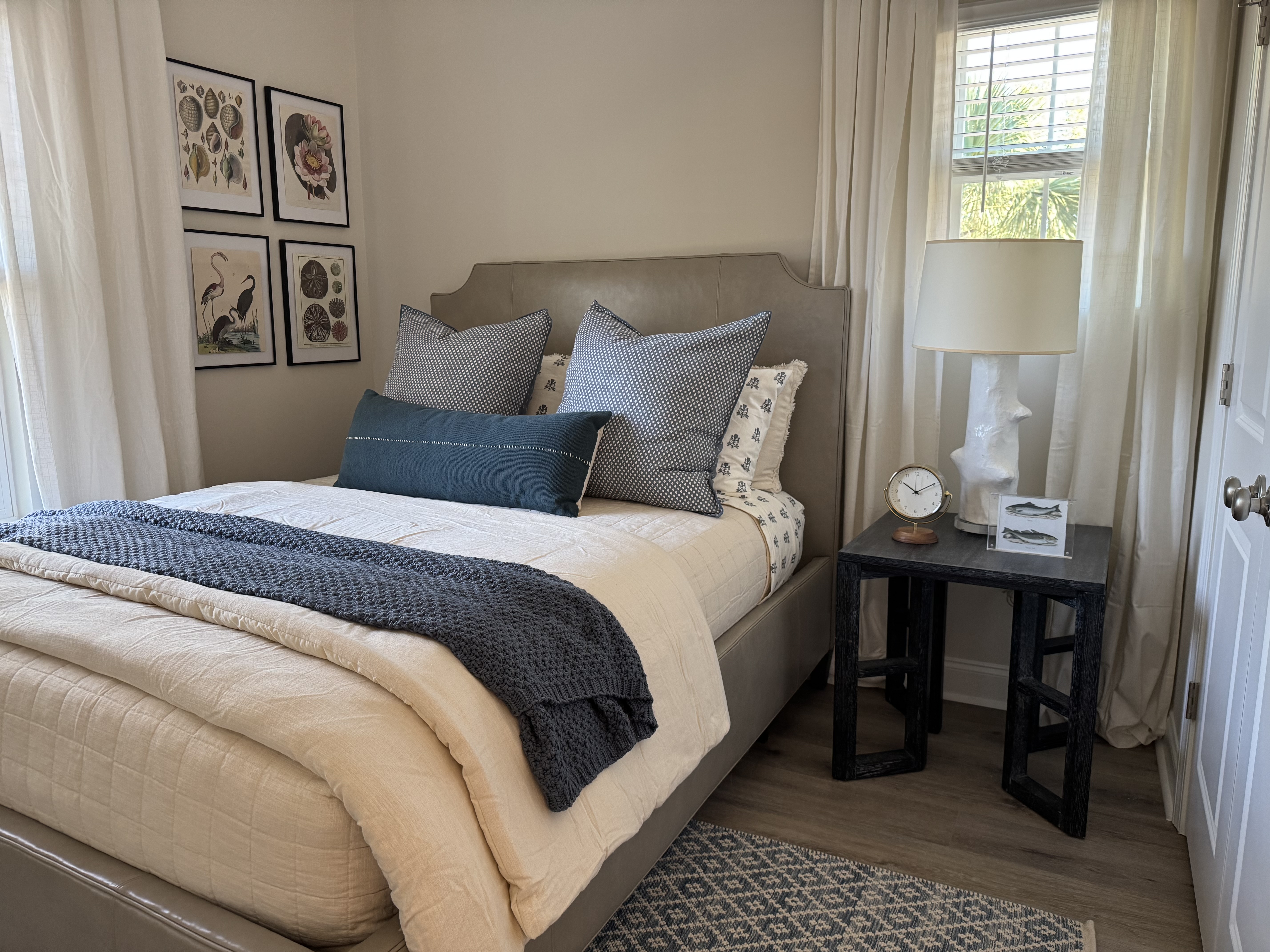 Nautical bedroom with gallery wall and navy throw