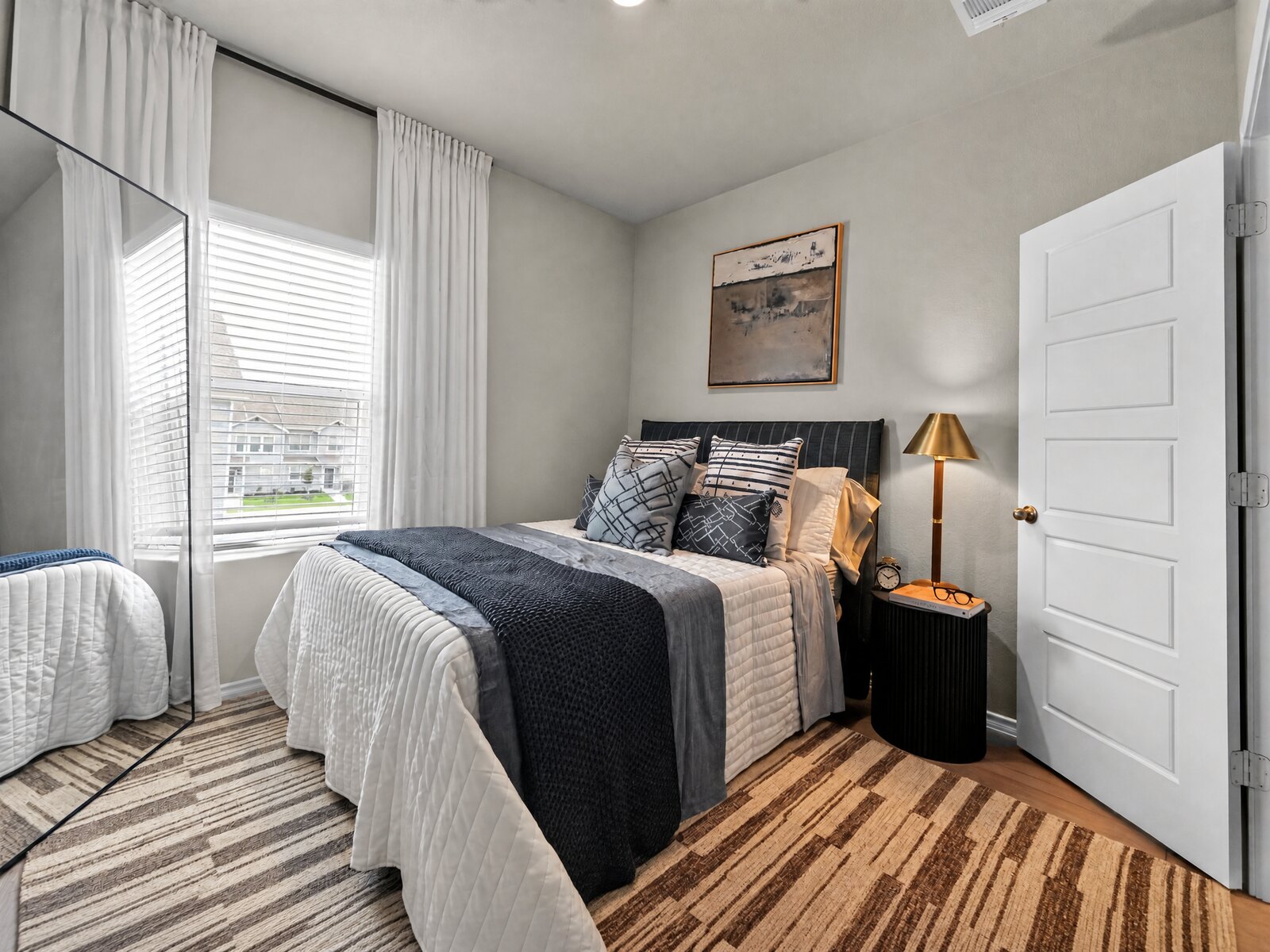 Guest bedroom with navy accents and layered textures