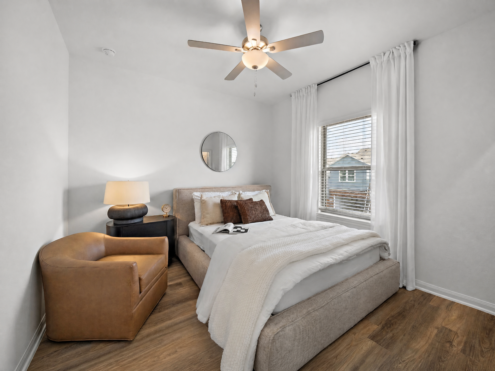 Warm guest bedroom with leather accent chair