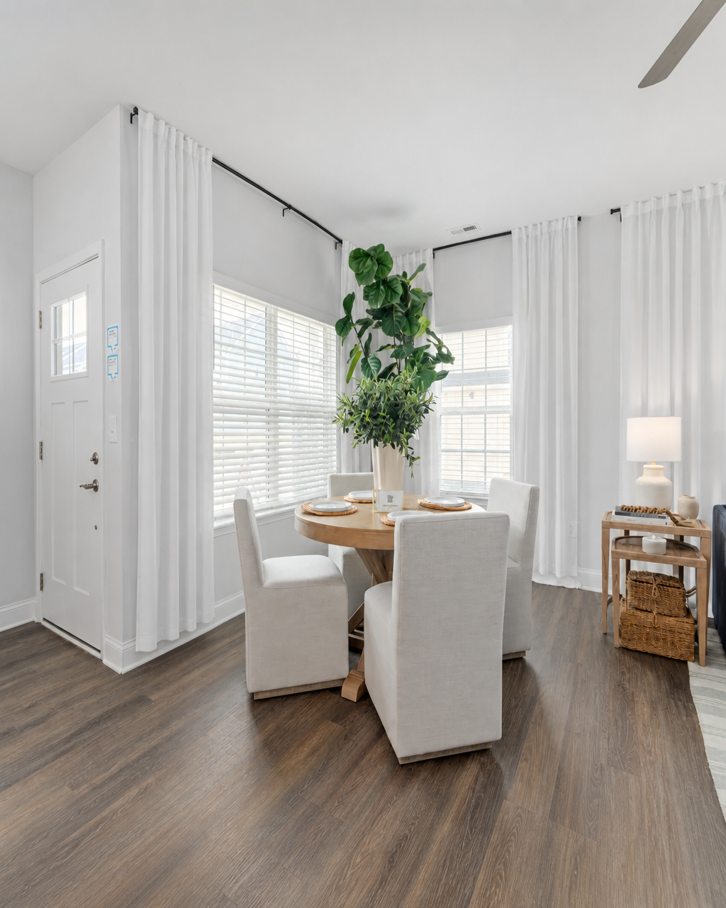 Bright dining nook with layered drapery