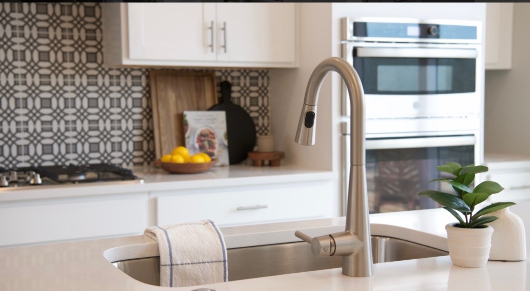 Kitchen detail with geometric backsplash and stainless fixtures