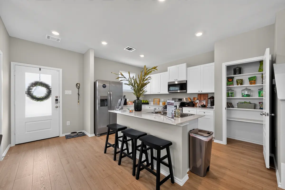 Bright kitchen with stainless appliances and white cabinetry