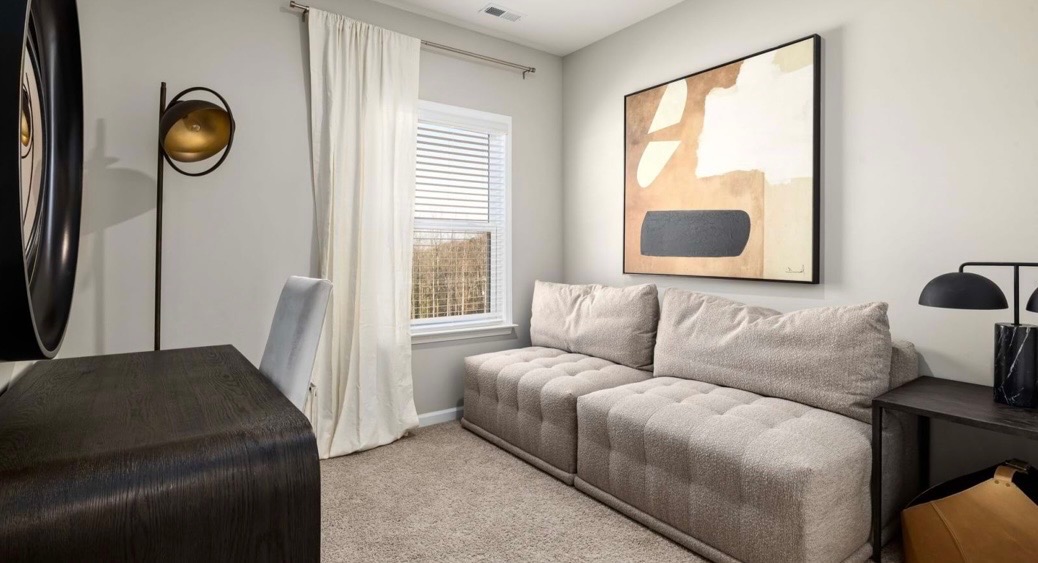 Cozy lounge with tufted sectional and abstract art