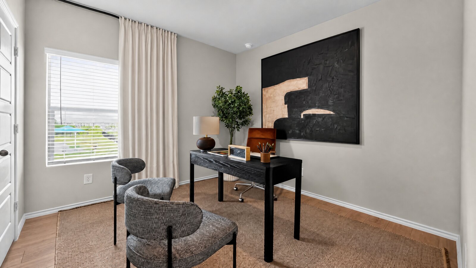 Sophisticated home office with bold black artwork