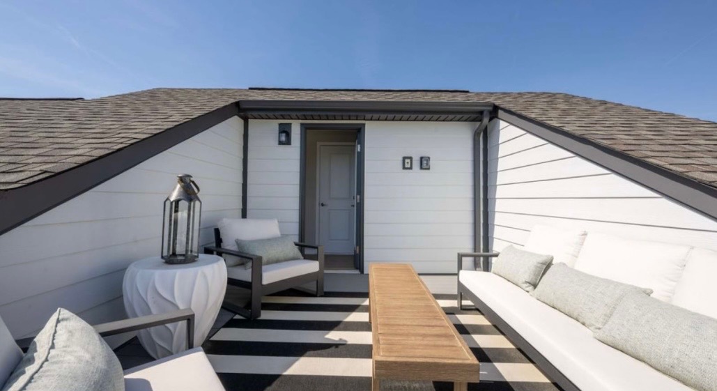 Rooftop terrace with striped rug and outdoor seating